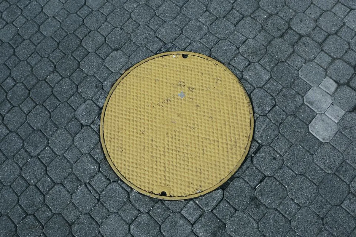 Sewer cleanout cover set into paving at a Murrieta property